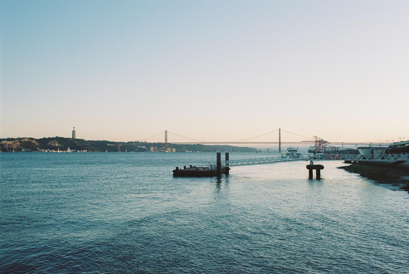 Tagus river waterfront with the 25 de Abril bridge at golden hour